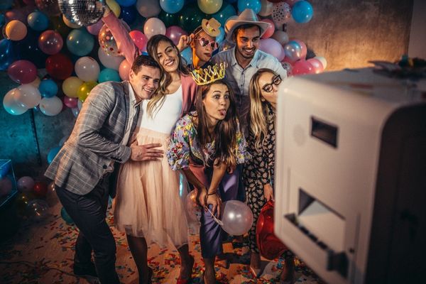 People posing together in photo boot