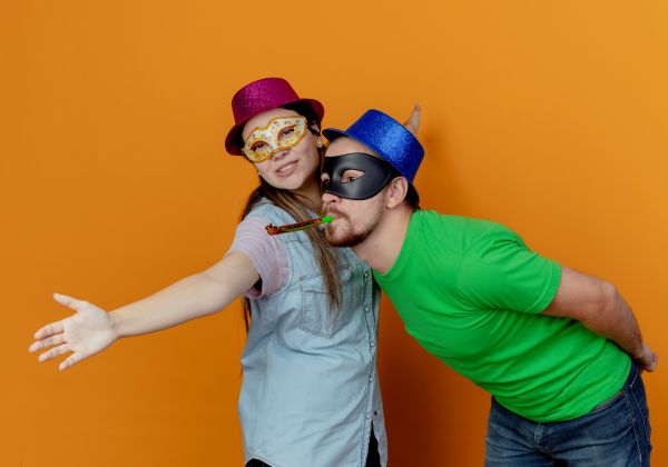 People posing in outdated photo booth backdrop