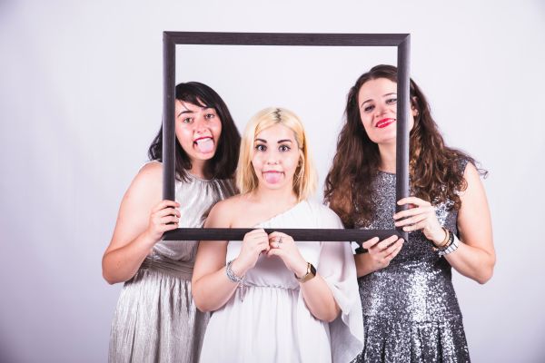 Group taking fun photo booth pictures