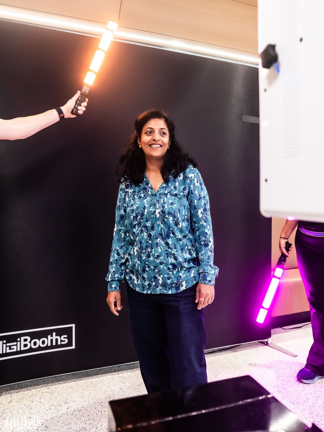 The same guest lit by a glowing magenta LED wand streak sweeping past