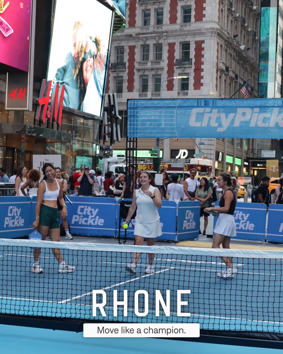 Players on the City Pickle court in Times Square with the Rhone branded overlay