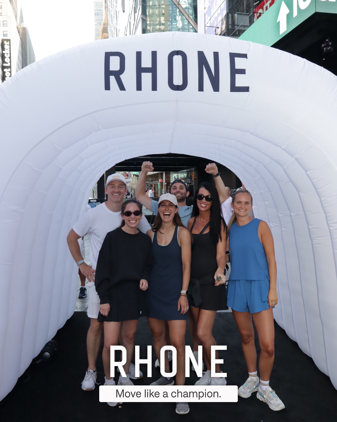 A group posing together in the branded Rhone tunnel at CityPicklePalooza, Times Square