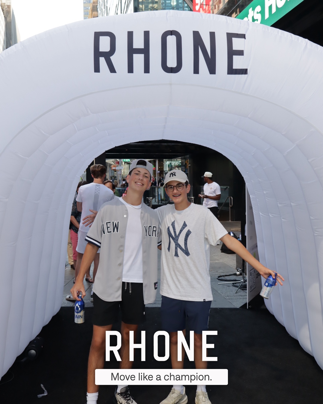 Two guests posing in the branded Rhone tunnel at the Times Square activation