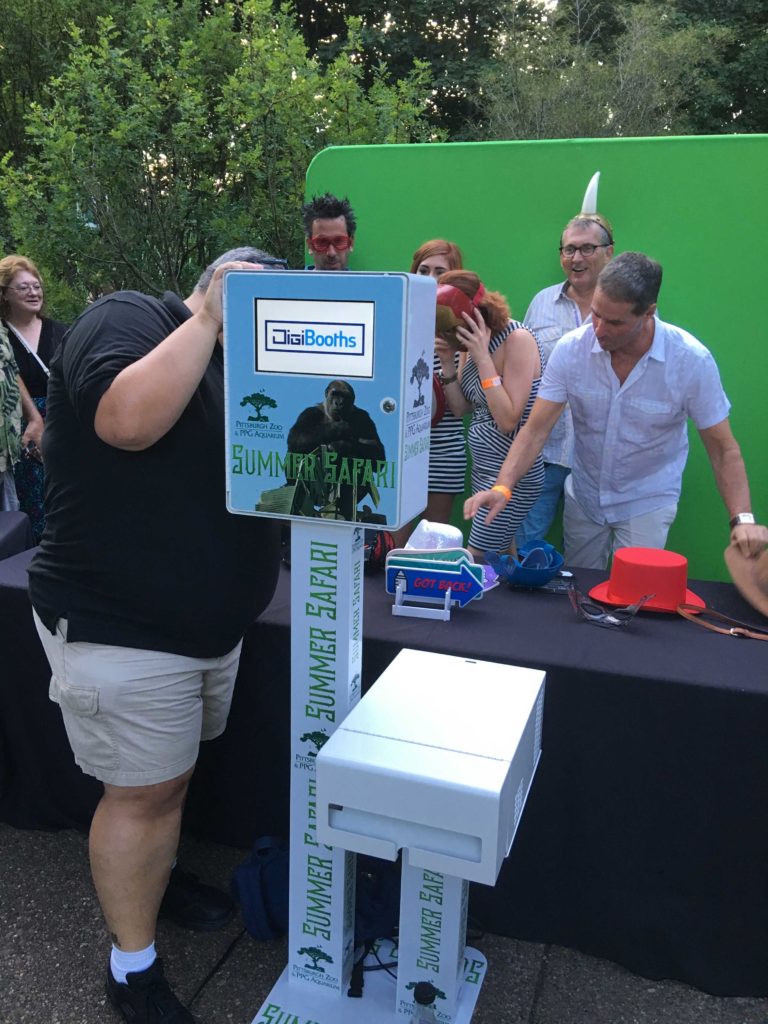 Group getting ready to take a photo in front of the green screen photo booth rental in Pittsburgh, PA