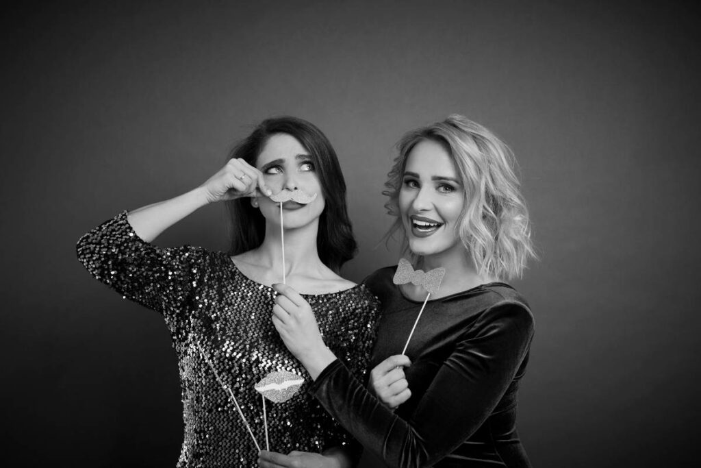Friends using a glam photo booth