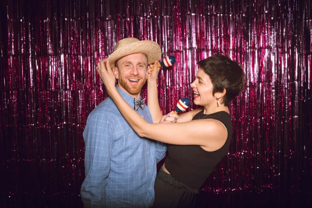 A couple enjoying the corporate event photo booth