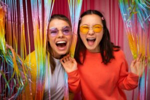 Friends posing in a photo booth rental
