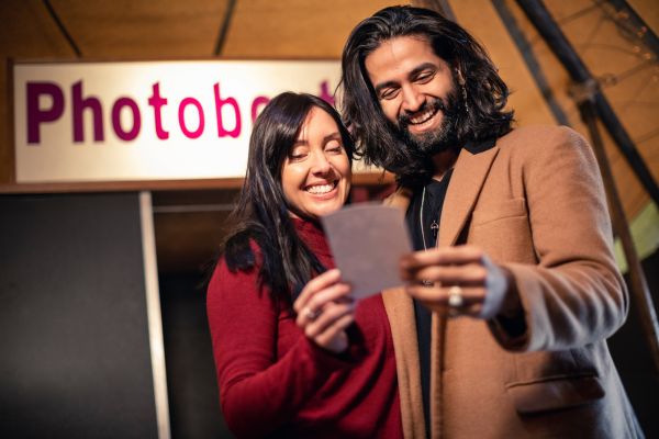 A couple smiling at their photo.