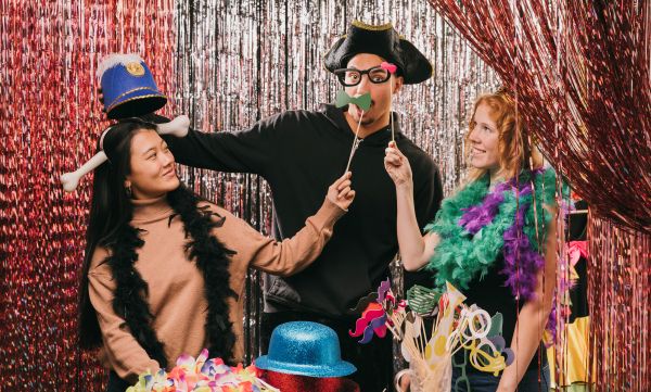 People posing with props in photo booth
