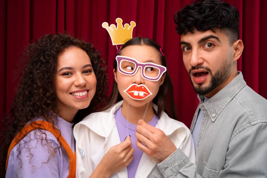 Friends trying out photo booth props