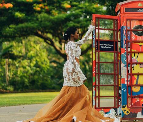 Elegant woman in formal dress using outdoor photo booth rental service.