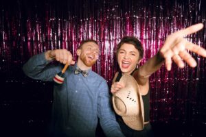 People posing inside a 360 photo booth