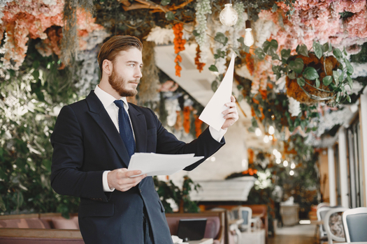 Professional man reviewing photo booth rental contract and documentation