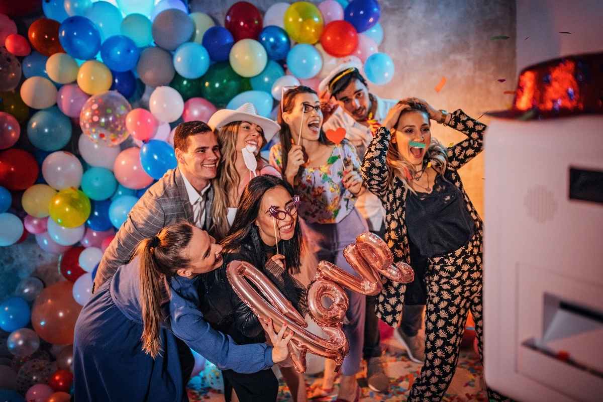 Friends posing for a picture using a GIF photo booth.