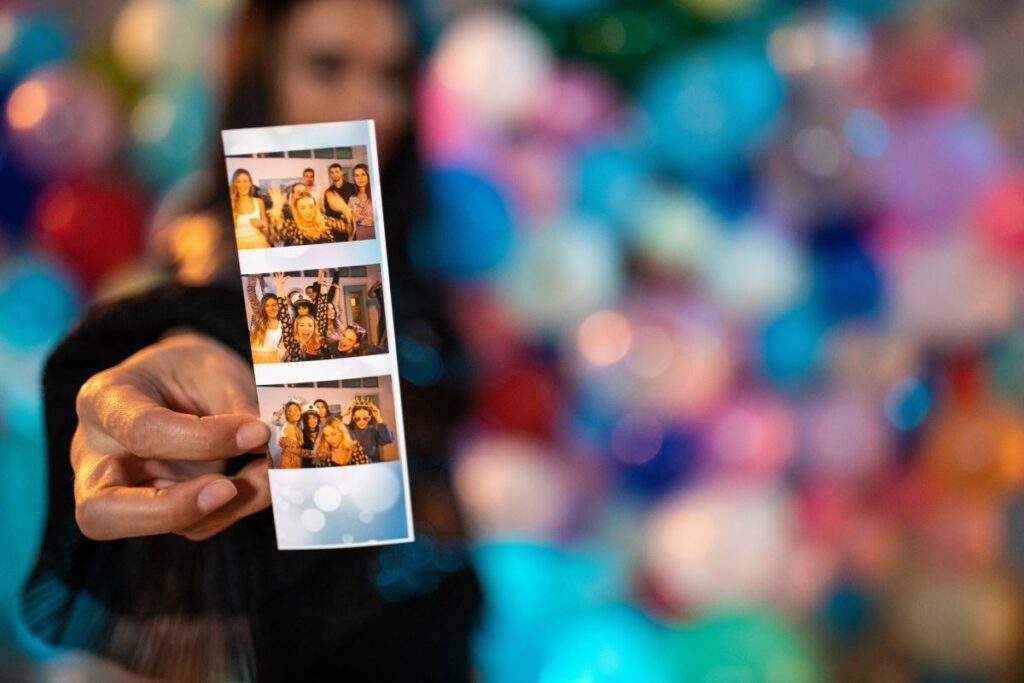 Woman holding printed photo booth picture