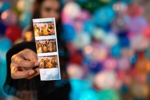 Woman holding printed photo booth picture