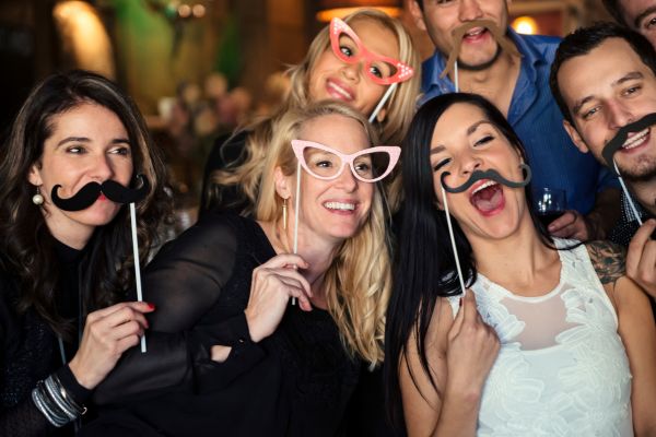 Colleagues taking a photo with a mirror photo booth.