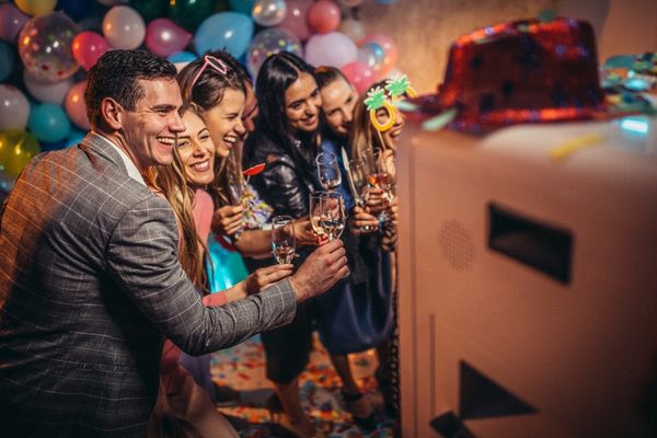 Guests smiling while using photo booth