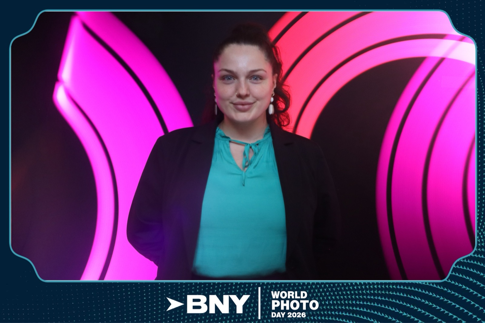 Finished light painting photo booth portrait — a guest framed by glowing pink and magenta long-exposure light arcs